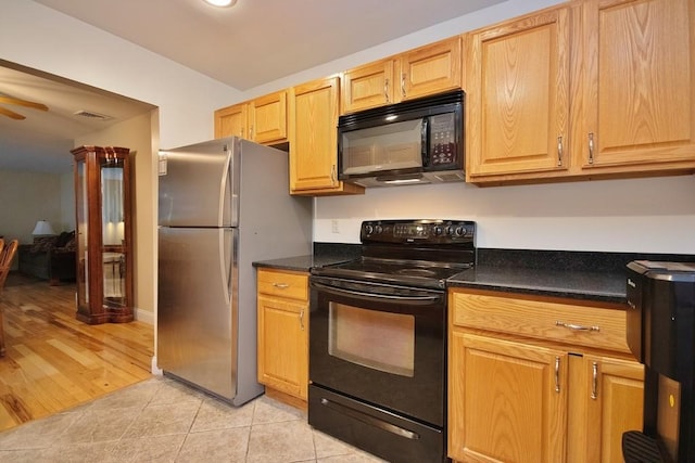 135 Cottage Rd, Carmel, NY 10512 - kitchen featuring black appliances, dark countertops, light tile patterned floors, and ceiling fan