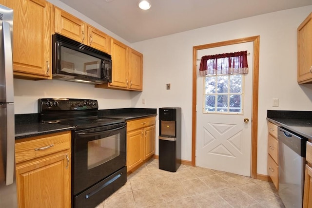 135 Cottage Rd, Carmel, NY 10512 - kitchen with black appliances, dark countertops, light tile patterned floors, recessed lighting, and baseboards