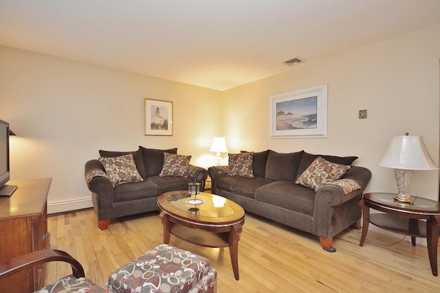 135 Cottage Rd, Carmel, NY 10512 - living room with light wood-type flooring, baseboards, and a baseboard heating unit
