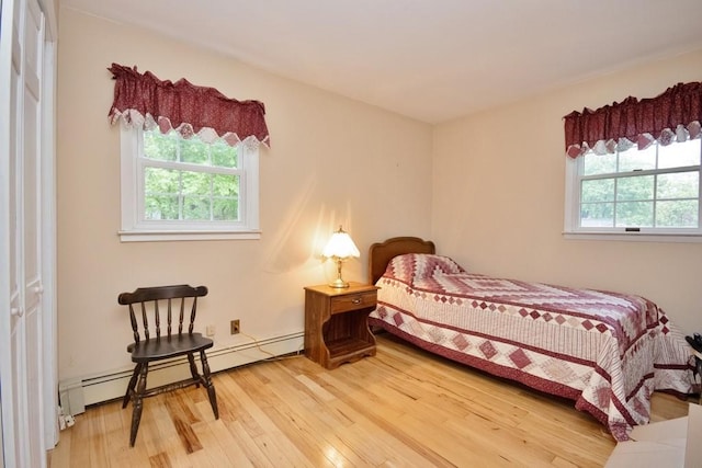 135 Cottage Rd, Carmel, NY 10512 - bedroom with light wood-type flooring and baseboard heating
