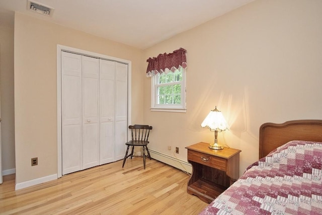 135 Cottage Rd, Carmel, NY 10512 - bedroom with a baseboard heating unit, wood finished floors, a closet, and baseboards