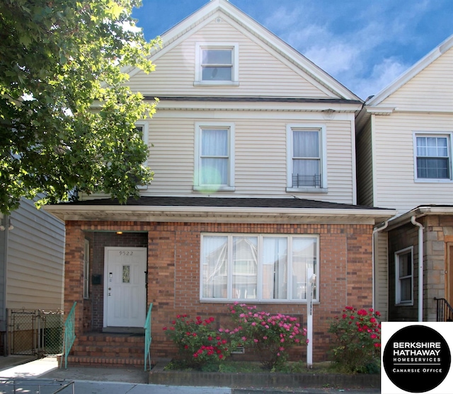 view of front of property with fence and brick siding
