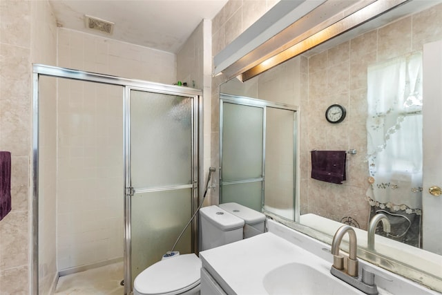 bathroom with toilet, a shower stall, and vanity