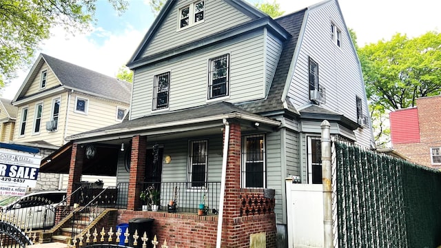 4308 68th St Unit 2Family, Woodside, NY 11377 - view of front of house featuring covered porch, roof with shingles, a gambrel roof, and fence