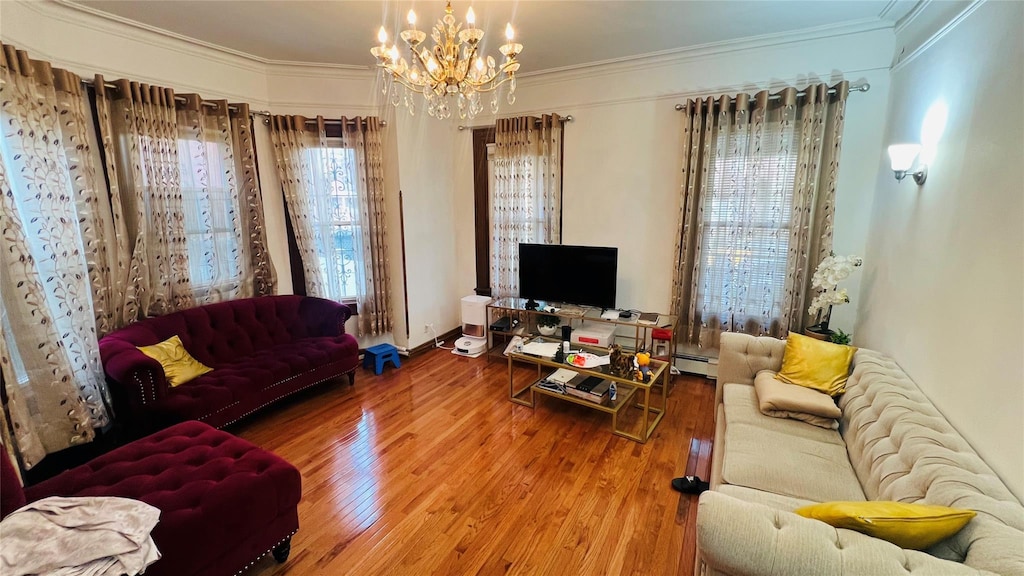 4308 68th St Unit 2Family, Woodside, NY 11377 - living room featuring wood finished floors, a chandelier, ornamental molding, and a baseboard heating unit