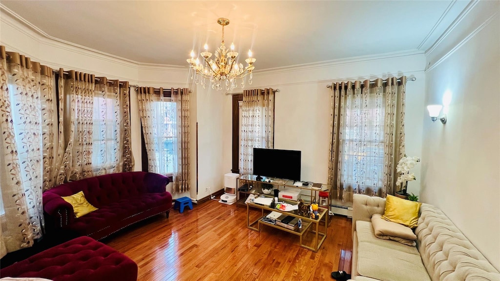 4308 68th St Unit 2Family, Woodside, NY 11377 - living area with a chandelier, ornamental molding, wood finished floors, and baseboard heating