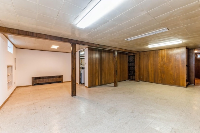 769 Anderson Ave, Franklin Square, NY 11010 - finished below grade area with radiator, tile patterned floors, and wood walls