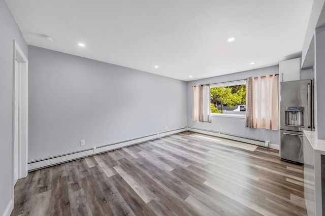 73 S Evergreen Dr, Selden, NY 11784 - unfurnished living room with baseboards, a baseboard radiator, recessed lighting, and wood finished floors