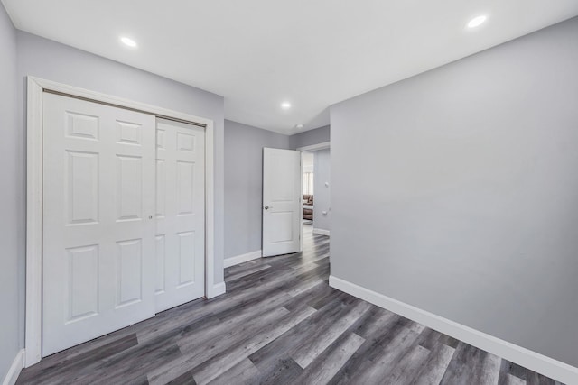 73 S Evergreen Dr, Selden, NY 11784 - unfurnished bedroom featuring dark wood-type flooring, baseboards, and recessed lighting