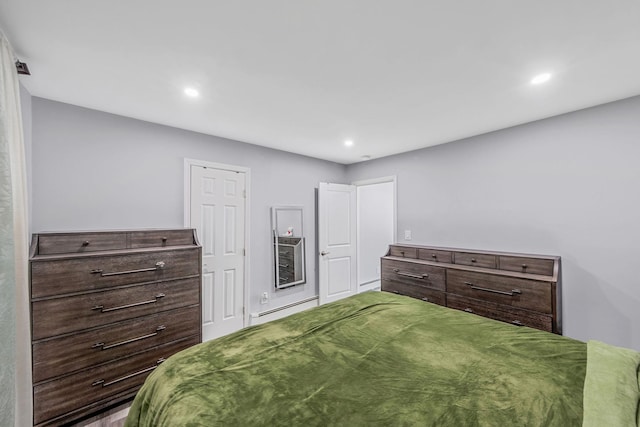 73 S Evergreen Dr, Selden, NY 11784 - bedroom with a baseboard heating unit, a baseboard radiator, and recessed lighting