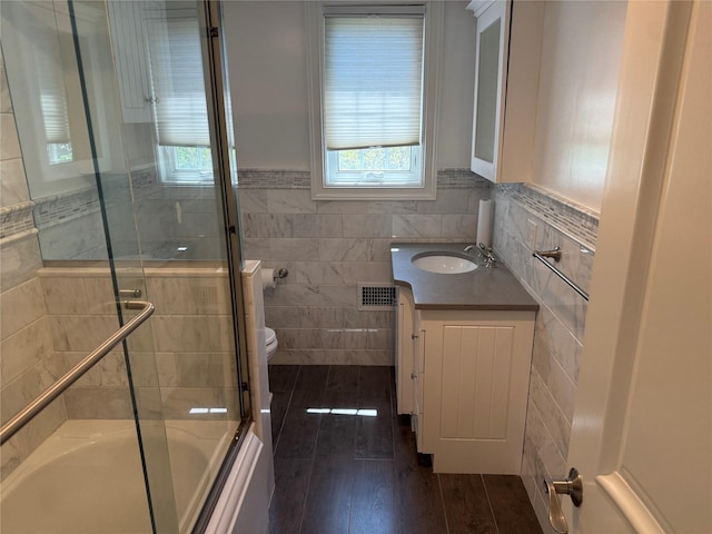 2330 Kingsland Ave, Bronx, NY 10469 - full bath featuring tile walls, healthy amount of natural light, vanity, a wainscoted wall, and toilet