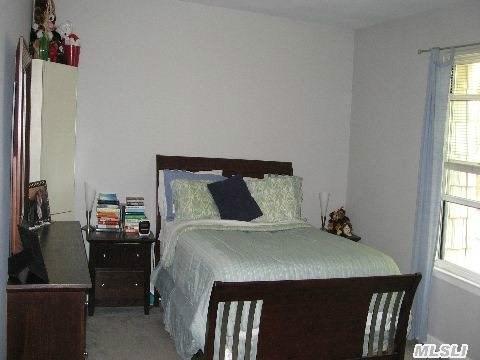 bedroom with multiple windows and carpet flooring