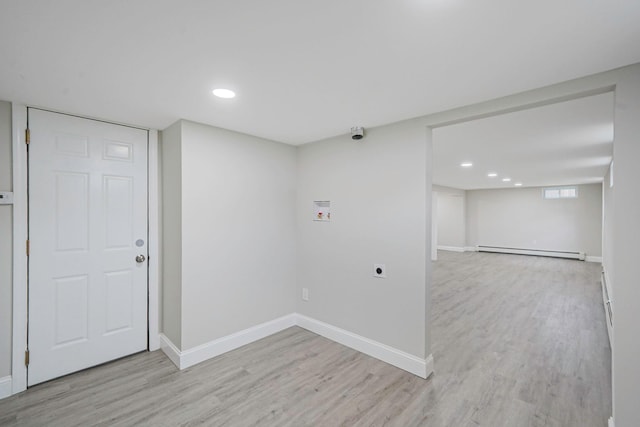 basement featuring a baseboard radiator, light wood-type flooring, baseboards, and recessed lighting