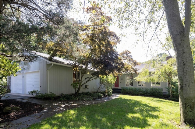 view of side of home featuring a yard and a garage