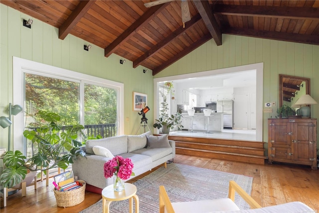 living area featuring light wood-style floors, wood walls, and wood ceiling