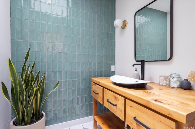 bathroom with vanity, tile walls, and tile patterned flooring