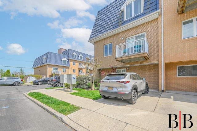 view of property featuring a residential view and uncovered parking