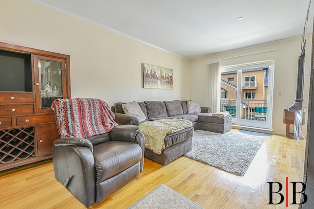 living room with light wood-style flooring and crown molding