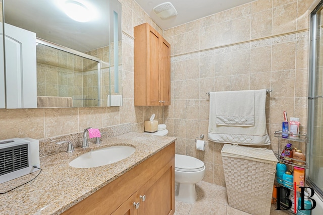 full bath featuring a stall shower, tile patterned floors, tile walls, backsplash, and vanity