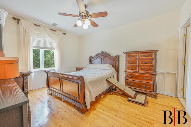 bedroom featuring ceiling fan, visible vents, and light wood-style floors