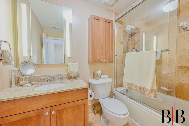 bathroom with toilet, shower / bath combination with glass door, tile patterned floors, visible vents, and vanity