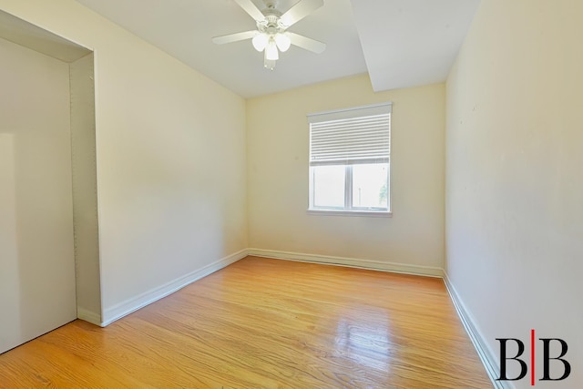 unfurnished room with baseboards, light wood-type flooring, and a ceiling fan