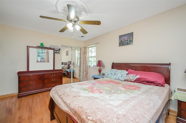 bedroom with a ceiling fan, a closet, baseboards, visible vents, and light wood-type flooring
