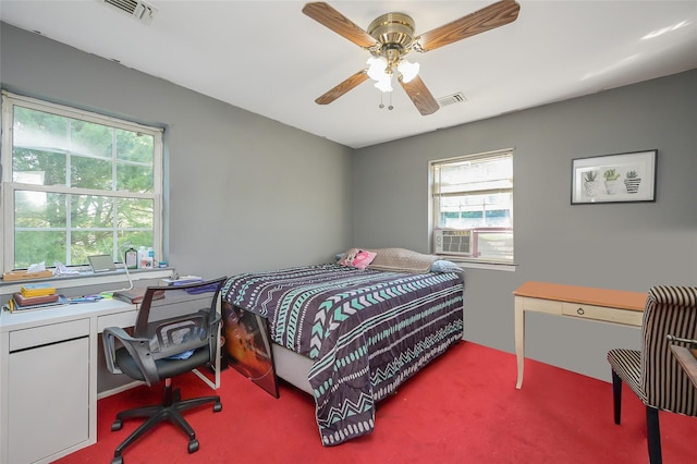 bedroom with carpet flooring, visible vents, a ceiling fan, and cooling unit