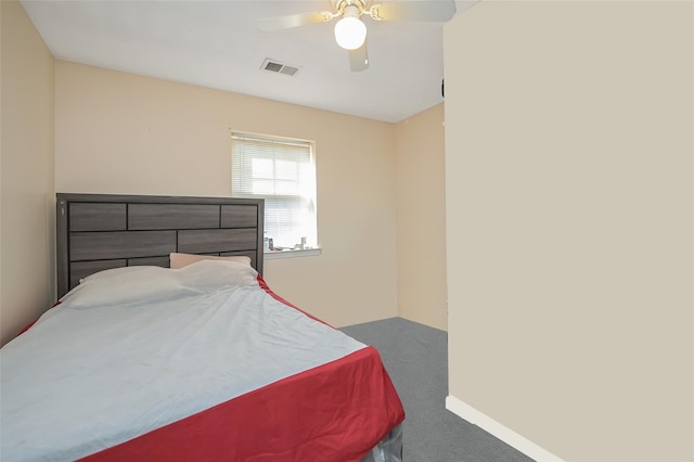 carpeted bedroom featuring visible vents, baseboards, and ceiling fan