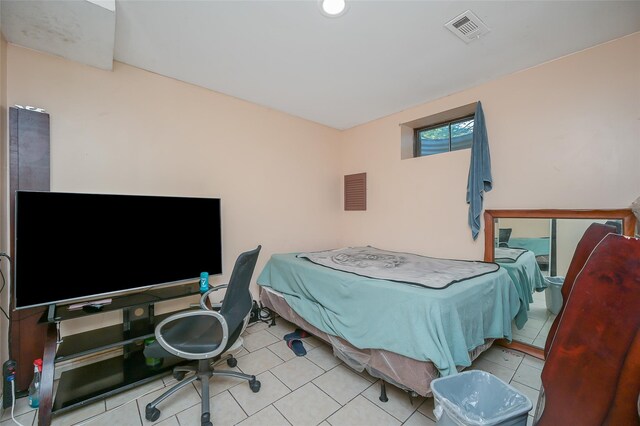 bedroom with tile patterned flooring and visible vents