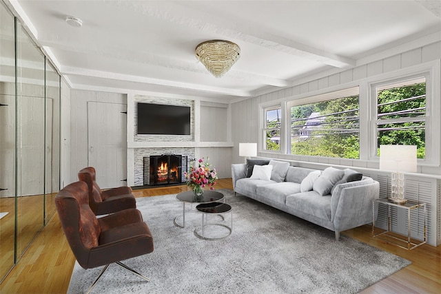 202 W Main St, Mount Kisco, NY 10549 - living room featuring wood finished floors, beamed ceiling, and a lit fireplace
