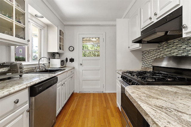 202 W Main St, Mount Kisco, NY 10549 - kitchen featuring stainless steel appliances, a sink, under cabinet range hood, tasteful backsplash, and white cabinets