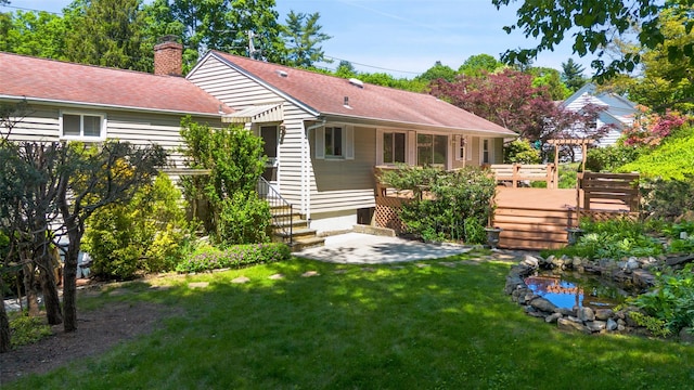 202 W Main St, Mount Kisco, NY 10549 - back of property featuring a chimney, a yard, a wooden deck, roof with shingles, and a pergola