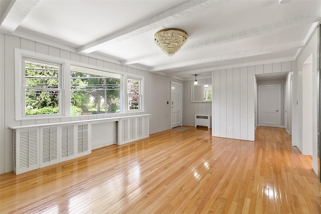 202 W Main St, Mount Kisco, NY 10549 - unfurnished living room with radiator heating unit, light wood-style flooring, and beamed ceiling