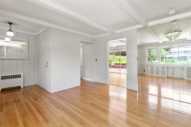 202 W Main St, Mount Kisco, NY 10549 - unfurnished room featuring radiator heating unit, light wood-style floors, beam ceiling, and a smoke detector