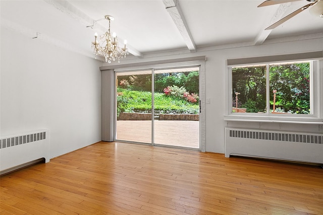202 W Main St, Mount Kisco, NY 10549 - unfurnished room featuring radiator heating unit, beam ceiling, plenty of natural light, and a chandelier