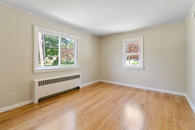 202 W Main St, Mount Kisco, NY 10549 - empty room with radiator heating unit, light wood-style flooring, ornamental molding, and baseboards