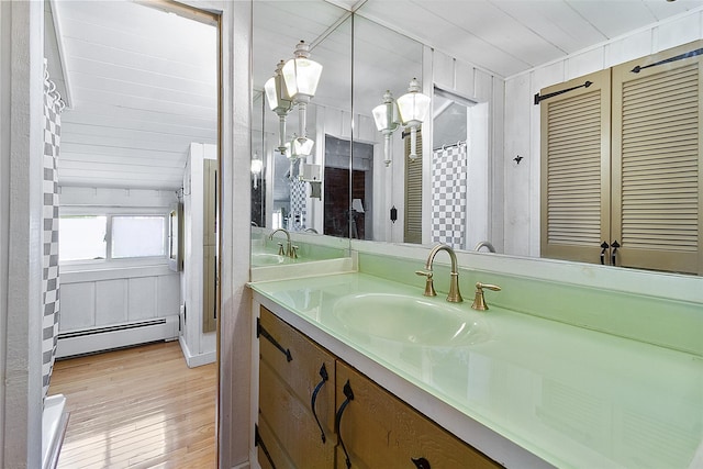 202 W Main St, Mount Kisco, NY 10549 - bathroom with a baseboard heating unit, vanity, and wood finished floors