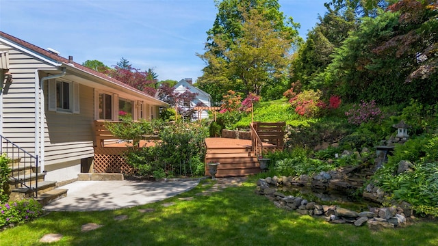 202 W Main St, Mount Kisco, NY 10549 - view of green lawn featuring a deck and a patio area