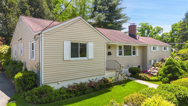 202 W Main St, Mount Kisco, NY 10549 - view of front of house with a chimney, a front yard, and roof with shingles