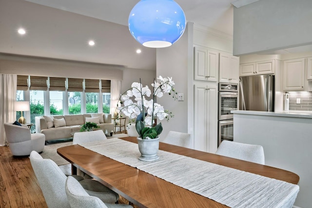 dining space with dark wood finished floors and recessed lighting