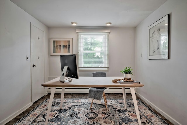 office area with baseboards and wood finished floors