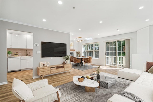1601 Pondcrest Ln, White Plains, NY 10607 - living area with a chandelier, recessed lighting, light wood finished floors, ornamental molding, and baseboards