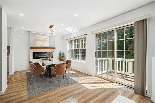 1601 Pondcrest Ln, White Plains, NY 10607 - dining room with healthy amount of natural light, a chandelier, wood finished floors, vaulted ceiling, and recessed lighting
