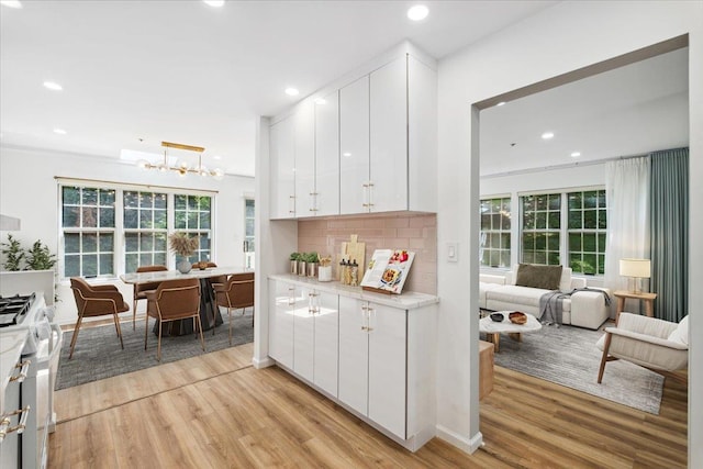 1601 Pondcrest Ln, White Plains, NY 10607 - kitchen with gas range, light wood-type flooring, recessed lighting, healthy amount of natural light, and light countertops