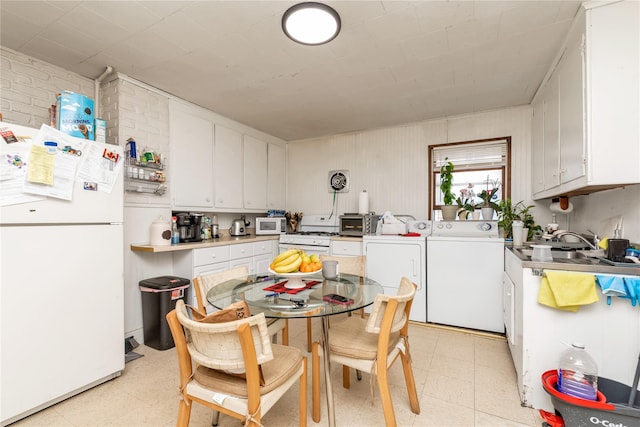 kitchen featuring white cabinets, independent washer and dryer, light floors, and white appliances