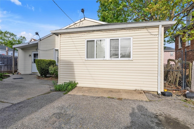 view of side of home with a patio area and fence
