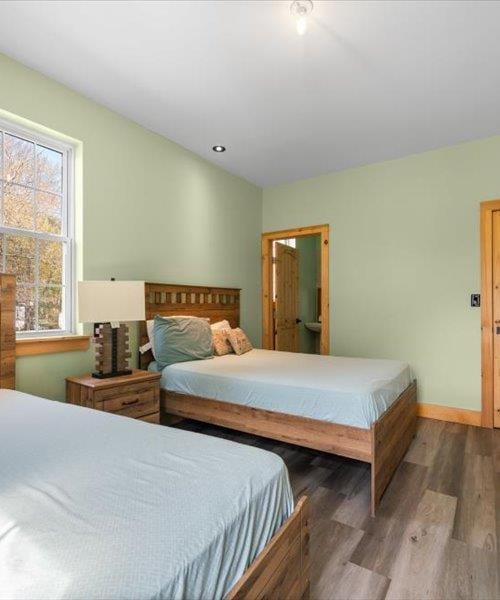 bedroom featuring wood finished floors and baseboards