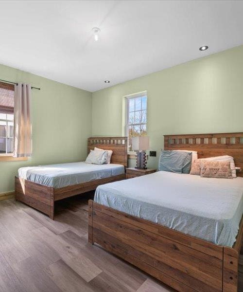 bedroom featuring wood finished floors and recessed lighting