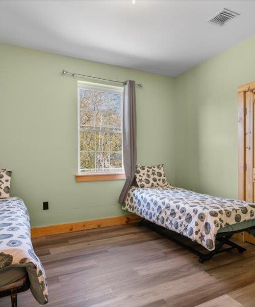 bedroom featuring wood finished floors and baseboards